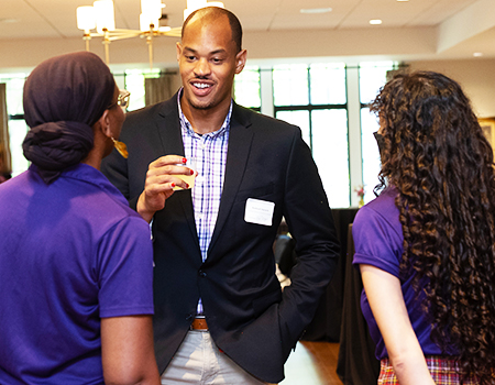 Assistant Director of Diversity and Inclusion Rashaad Barnett listening to his colleagues