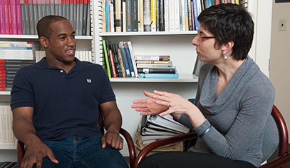 faculty and student engaged in a discussion