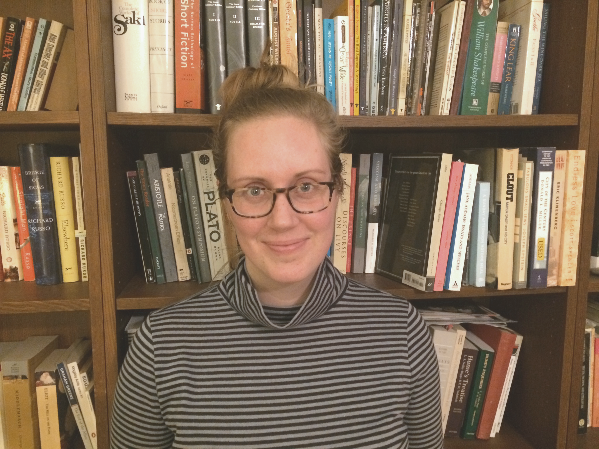 Ruth standing in front of bookshelves